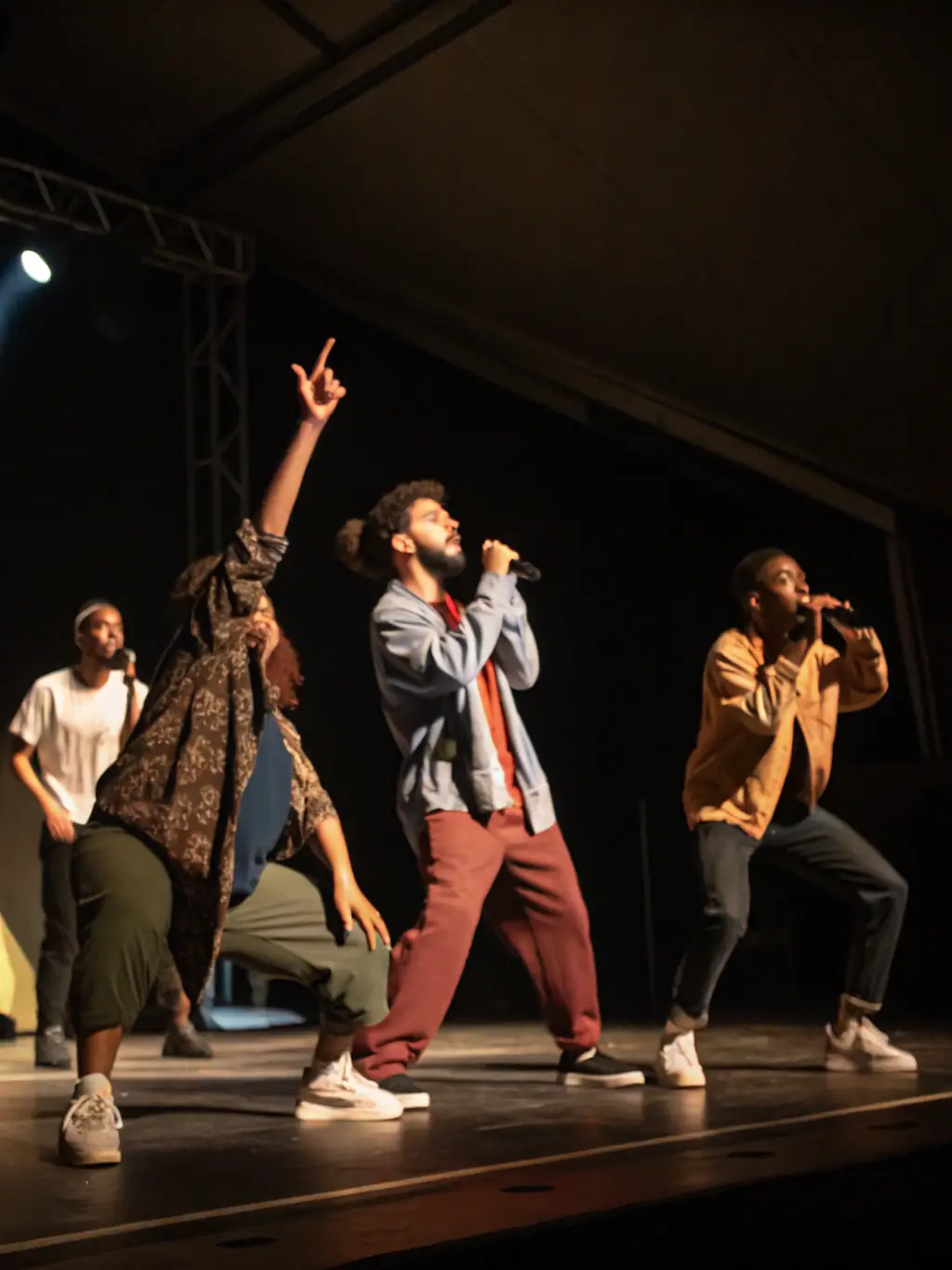 A dynamic image of a diverse group of performers on stage during a theatrical production, highlighting the artistic talent ARBRAZIK supports.